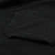 A textured fabric displays a dark hue, with a visible pocket stitched onto its surface, emphasizing a thick, fuzzy appearance. The background shows a continuation of the same material.