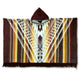 A hooded poncho displays a geometric design in brown, orange, and cream tones, with fringe at the bottom. The pattern includes diamonds and zigzag lines, creating a rich, textured appearance.