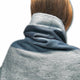 Toacazo baby alpaca wool blanket – a person wears a textured, gradient blue blanket around their neck, with brown hair visible above. The blanket appears soft and is the main focus against a plain white background