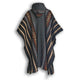Poncho with geometric patterns and a hood, featuring brown, black, and white stripes and diamond designs; displayed against a plain white background.