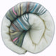 Sigchos baby alpaca wool blanket – a rolled-up blanket features colorful stripes, including gray, pink, blue, and green sections. It is neatly coiled, with a white background providing a simple, uniform setting