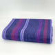 Punguloma baby alpaca wool blanket – folded woolen blanket displays horizontal stripes in shades of purple, red, and blue, placed on a neutral surface with a soft white background
