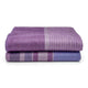 Chuquipata baby alpaca wool blanket – two folded purple blankets rest neatly on a white surface, displaying a pattern of alternating stripes in various purple hues