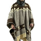 A person is wearing a patterned poncho with brown and cream geometric designs and fringed edges, standing against a plain background.