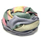 Guagua baby alpaca wool blanket – a multicolored, striped blanket is tightly coiled, showcasing pastel shades of pink, green, yellow, and purple. The soft, woven fabric appears plush, set against a white background