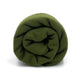 A rolled-up green blanket rests against a white background, showcasing soft fabric and a snug, cylindrical form.