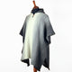Zuleta llama wool hooded poncho – a gray and white poncho displayed on a mannequin, featuring a central pattern with vertical stripes. The mannequin stands against a plain white background, highlighting the poncho's texture