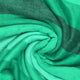 Yatzaputzan baby alpaca wool blanket – green fabric forms a spiral, creating a textured appearance with varying shades from light to dark. The folds create a swirling pattern, resembling a soft, abstract design