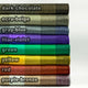 Yatzaputzan baby alpaca wool blanket – stacked rolls of fabric, each labeled by color. From top to bottom: dark chocolate, ecru-beige, gray-blue, lilac-violet, green, yellow, red, purple-bronze. All are set on a neutral background