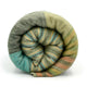 Cojitambo alpaca wool throw blanket – a rolled-up, multicolored striped blanket rests against a white background, showcasing a blend of greens, blues, and oranges in a snug, cylindrical shape