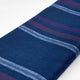 Tamboloma baby alpaca wool blanket – a folded dark blue wool blanket featuring horizontal purple and light blue stripes sits against a plain white background