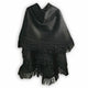 A black fabric shawl features decorative fringe along the edges. It is displayed hanging against a plain, white background.