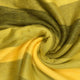 Yatzaputzan baby alpaca wool blanket – a soft, yellow and green fabric is tightly twisted into a spiral, showcasing its texture and color gradient, possibly on a flat surface or table