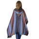 A person stands wearing a hooded, multicolored striped poncho in a white background, showcasing the back view with cascades of blue, red, and brown hues.
