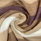 Yatzaputzan baby alpaca wool blanket – a soft, multi-colored fabric swirls into a spiral, featuring shades of beige, white, and maroon, creating a textured and flowing pattern