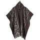 Llama Wool Hooded Poncho – a wool poncho featuring geometric patterns in white on a dark background, displayed hanging with a buttoned neck flap. The design includes symmetrical lines and diamond shapes
