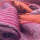 Pallatanga baby alpaca wool blanket – a textured, striped woolen fabric in shades of purple and rust lies gently folded, showcasing its soft fibers in a close-up view