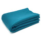 Moyaschucho baby alpaca wool blanket – a teal fabric blanket is neatly folded into a rectangular shape, set against a plain white background, emphasizing its smooth texture and vibrant color