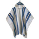 Poncho with hood, featuring blue and gray vertical stripes, hanging against a plain background. The fabric appears woven with a button near the neck area for fastening.