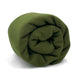 A rolled-up olive green blanket lies against a plain white background, emphasizing its soft texture and compact arrangement.