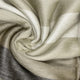 Yatzaputzan baby alpaca wool blanket – beige and cream plaid fabric, swirled in a spiral pattern with soft folds. The texture is woolly, creating a cozy and warm appearance