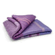 Chuquipata baby alpaca wool blanket – a folded purple blanket displays stripes of varying shades, laid on a plain white surface, highlighting its texture and design