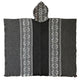 A woven poncho with black and white geometric patterns lies flat. It features two vertical patterned stripes and a matching hood. The background is plain and neutral.