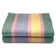 Guagua baby alpaca wool blanket – a folded, striped blanket with green, pink, lavender, and yellow stripes rests on a white background, highlighting its soft, textured fabric