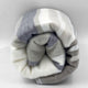 Yacoubina baby alpaca wool blanket – a rolled-up blanket with gray and cream stripes lies against a plain white background