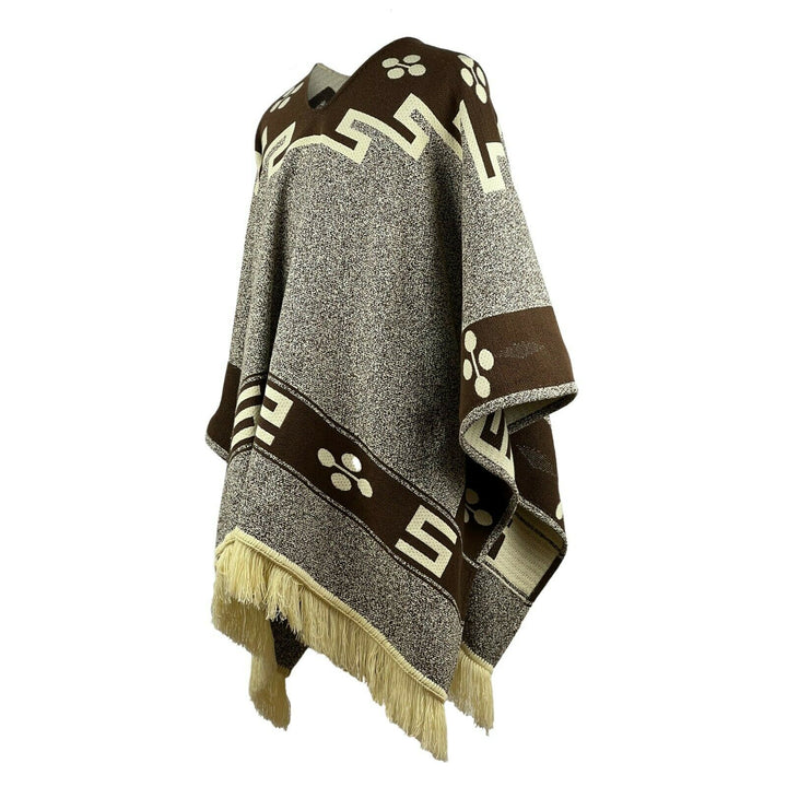 A brown and grey wool poncho hangs loosely, featuring geometric patterns and fringe edges, displayed against a plain white background.