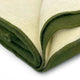 A folded, two-toned wool blanket with cream and olive green colors, lies neatly on a white background, showcasing its soft texture and contrasting edging.