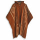 Llama Wool Hooded Poncho – a brown wool poncho with a hood and geometric patterns hangs on a hanger, featuring diamond and line designs in lighter tones. The background is plain white