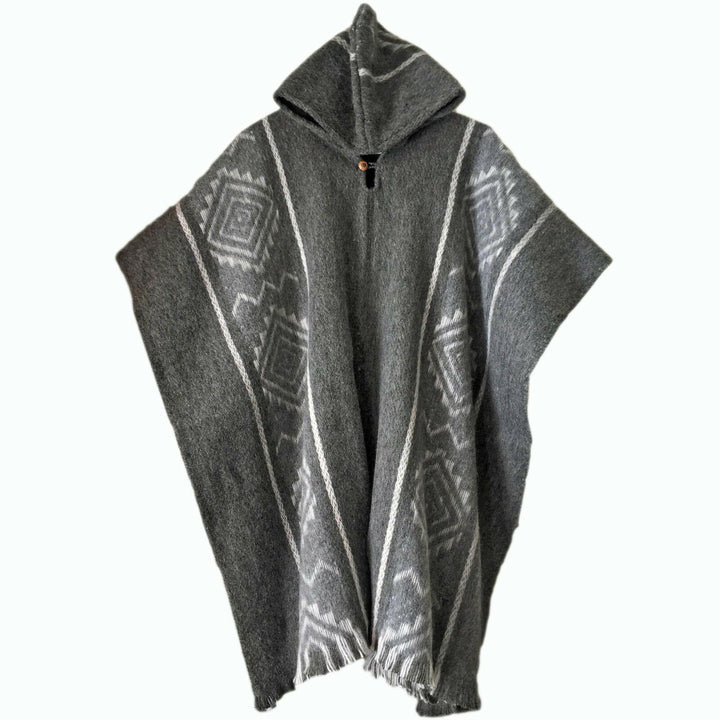 A gray poncho with geometric patterns drapes on a plain background. It features a hood and a wooden toggle at the neckline, displaying a blend of traditional and casual style.