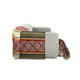 A gray sofa displays a colorful blanket with diamond and stripe patterns, draped over its back and side, against a plain white background.