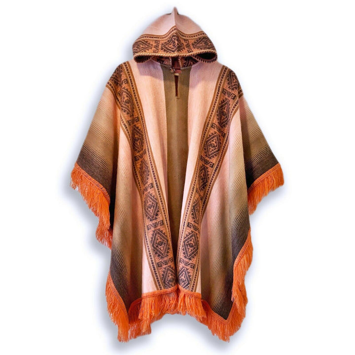 A hooded poncho hangs against a white backdrop, featuring earthy tones with geometric patterns and vibrant orange fringe trim along the edges.