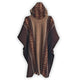 A hooded poncho hangs, displaying intricate geometric patterns in brown and beige. The garment's textured fabric and flowing design suggest warmth and comfort, set against a plain background.