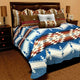 Bed showcasing patterned pillows and a blanket, predominantly blue with geometric designs, set in a room with nightstands and lamps on either side.