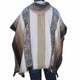 The poncho features patterned beige, white, and gray vertical stripes, worn by a person standing against a white background.