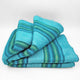Machay baby alpaca wool blanket – a neatly folded, striped wool blanket in shades of blue and green is resting against a plain white background