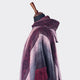 A mannequin displays a maroon-and-gray fringed poncho with geometric patterns, set against a plain white background.