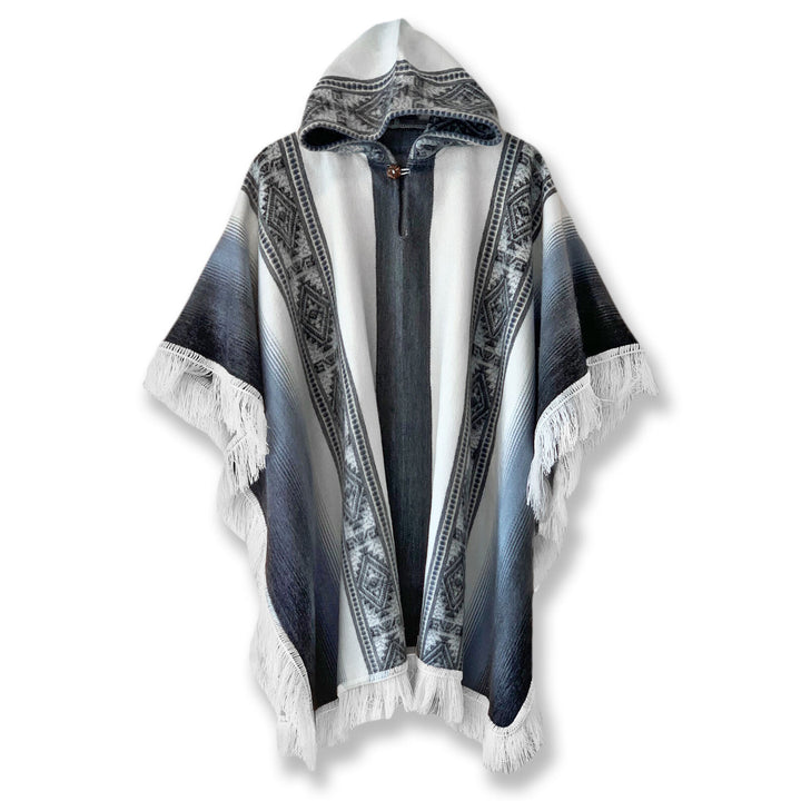 Palora lightweight alpaca wool hooded poncho – a hooded poncho with black-and-white geometric patterns and fringe along the edges. The poncho is displayed against a plain white background