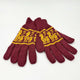 Burgundy knit gloves rest on a flat surface, featuring a yellow pattern of prancing animals. The design spans across the top, adding decorative detail. The background is plain white.
