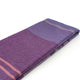 Chuquipata baby alpaca wool blanket – a folded blanket lies flat, displaying a striped pattern in varying shades of purple and pink, set against a plain white background