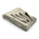 Deleg baby alpaca wool blanket – a neatly folded beige and gray blanket with subtle striped patterns, lying on a white surface