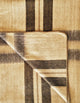 Wholesale lot of 45 queen alpaca wool blankets – a beige and brown plaid fabric with large overlapping stripes is shown partially folded at the corner, creating a layered visual effect against a flat surface
