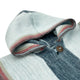 Hooded sweater rests folded; featuring a textured knit with horizontal gray, white, and pink stripes. A single brown button fastens near the neck, in a simple, close-up view.