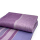 Chuquipata baby alpaca wool blanket – a folded, purple wool blanket with wide and narrow stripes resting on a flat surface, showcasing different shades of purple against a plain white background