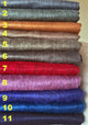 Apatug baby alpaca wool blanket – eleven rolls of colorful fabric are stacked vertically, each labeled with numbers one to eleven in yellow, ranging from gray to navy in a neutral setting