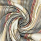 Ducur baby alpaca wool blanket – the striped fabric, featuring muted earth tones, swirls into a spiral pattern, creating a dynamic visual texture