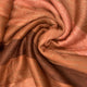 Yatzaputzan baby alpaca wool blanket – fabric with shades of rust and brown swirls in a crumpled pattern. The texture is soft and woven, creating a warm, cozy appearance